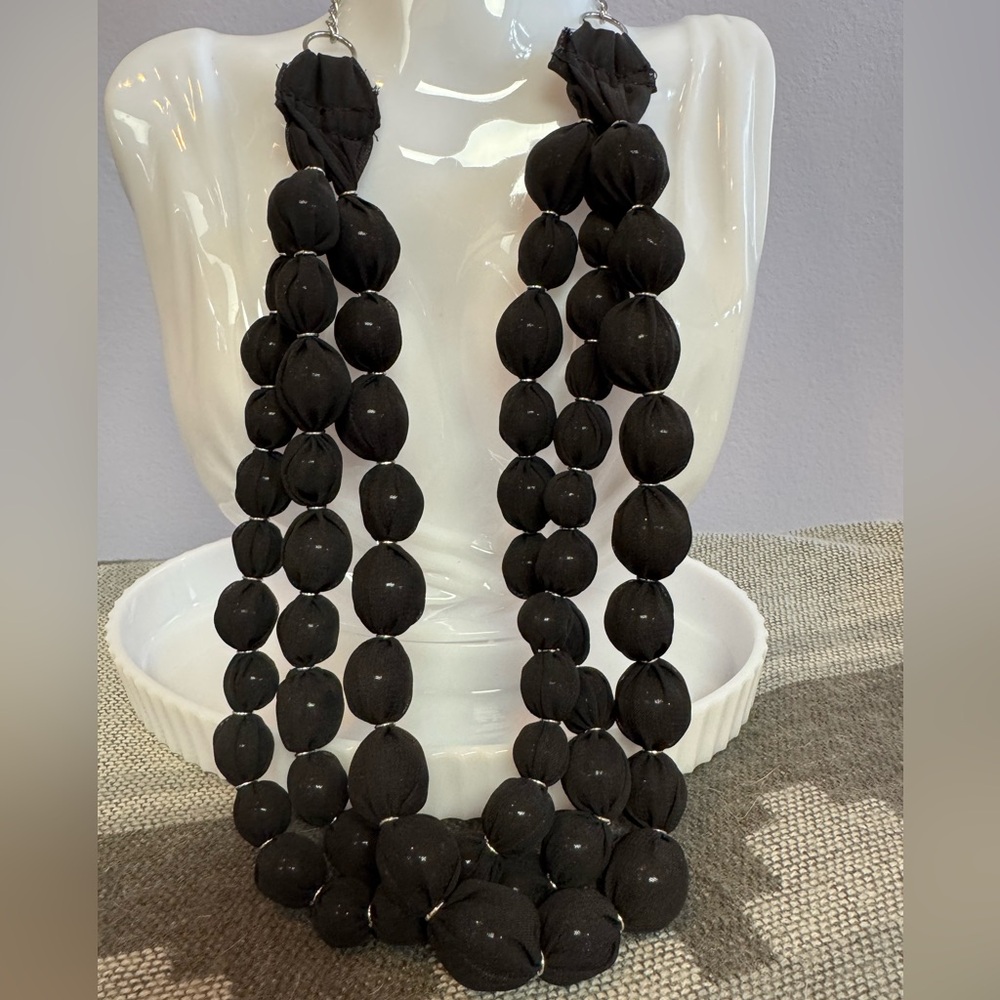 Ball necklace, glass beads covered with fabric.